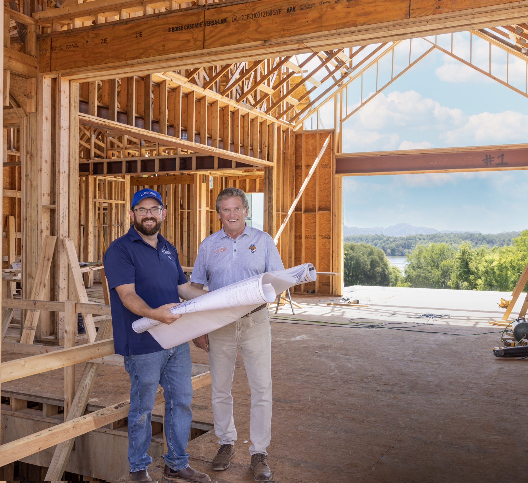 Providence Builders reviewing plans inside a custom home under construction