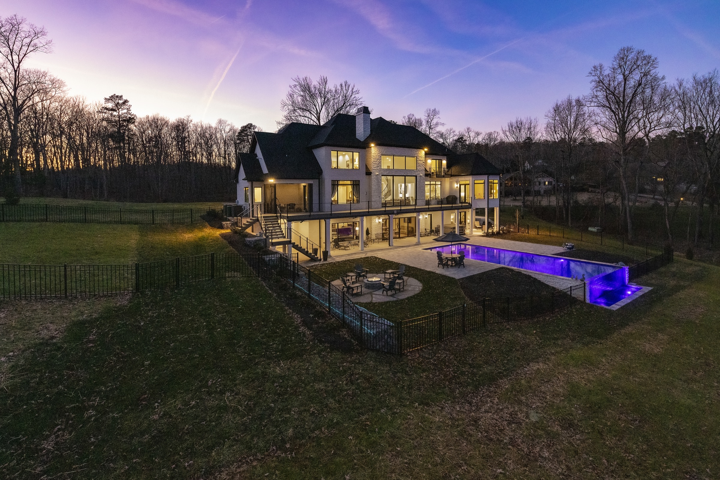 Finished custom home and pool photographed at dusk